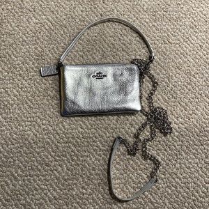 Silver coach wristlet with strap attachment